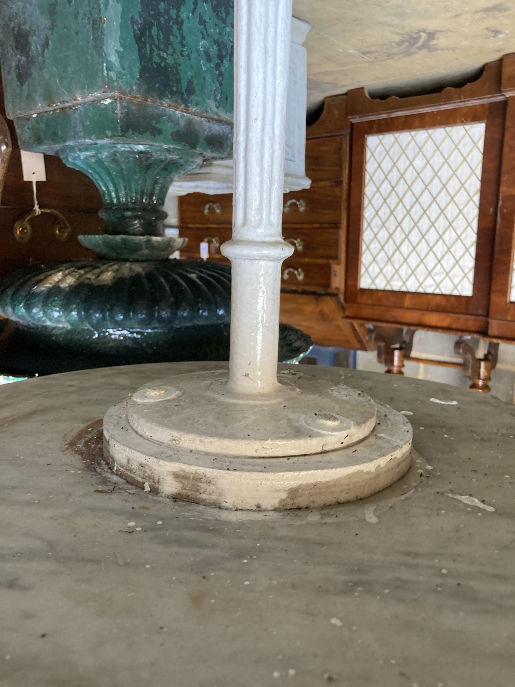 A Victorian marble topped cast iron garden table, diameter 50cm, height 72cm